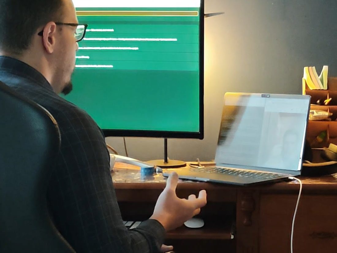 Eduardo at his desk in 2025, working at a terminal